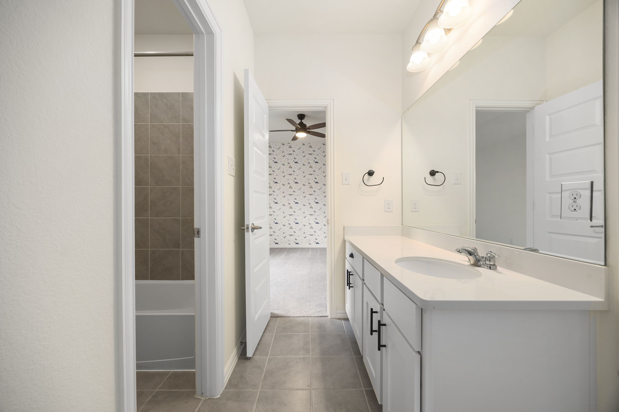 1098 Cherrystone Loop Buda, TX 78610 - Photo 28 of 37 a bathroom with a double vanity sink a and a shower