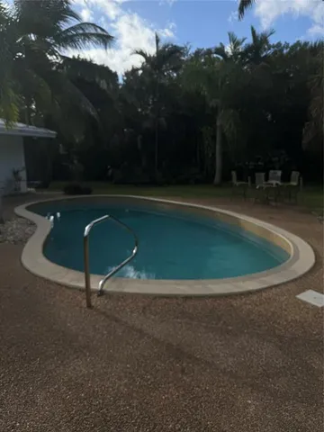 a view of a swimming pool with a yard