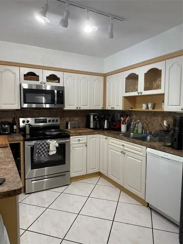a kitchen with stainless steel appliances granite countertop a stove and a sink