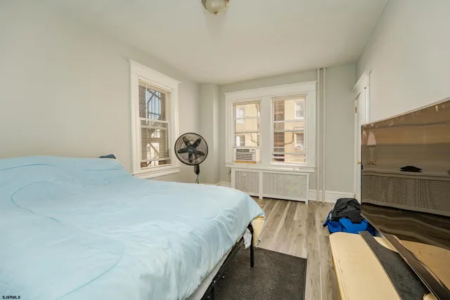 a bedroom with a bed and a large window