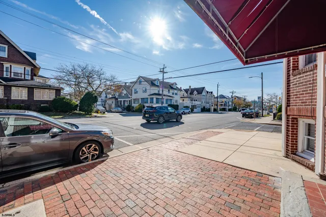 a view of a cars park in front of a building
