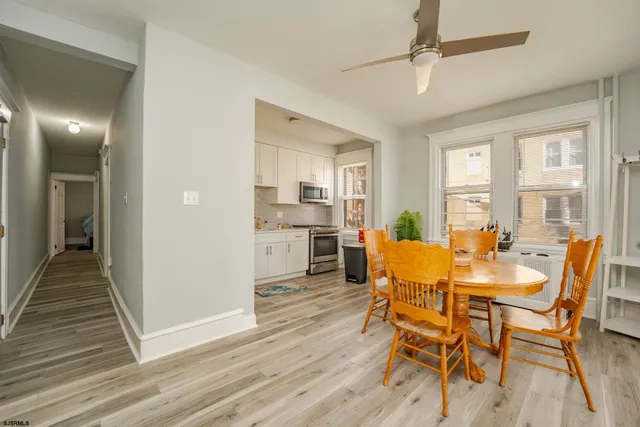 a view of a dining room with furniture and wooden floor