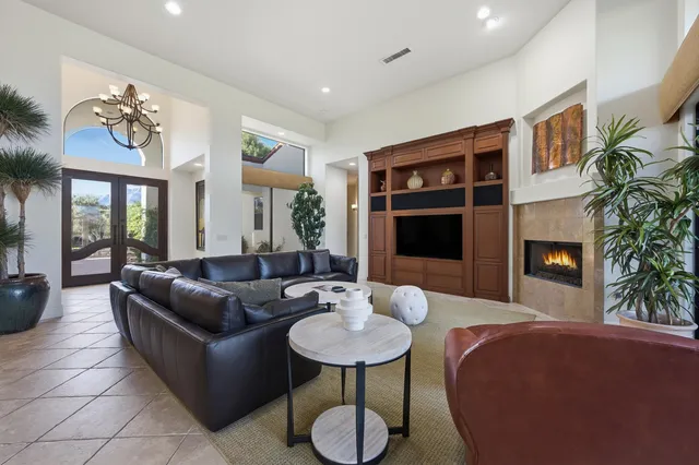 a living room with furniture potted plant and a fireplace