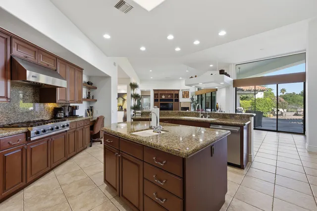 a kitchen with granite countertop counter top space a sink stainless steel appliances and cabinets