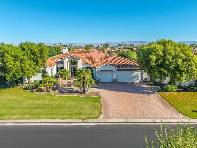 an aerial view of a house with swimming pool garden and patio