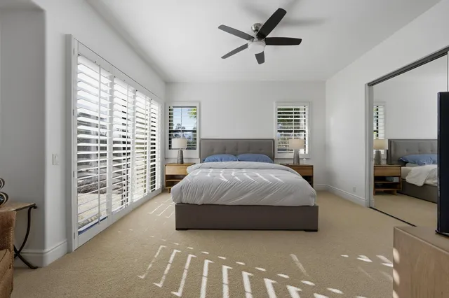 a bedroom with a large bed and a large window