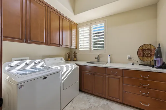 a utility room with sink dryer and washer