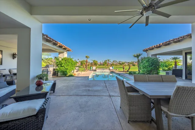 a view of a patio with table and chairs