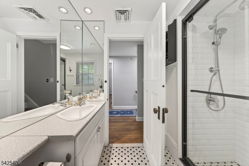 28 Spring Ridge Drive Berkeley Heights, NJ 07922 - Photo 25 of 46 a bathroom with a granite countertop shower sink and mirror