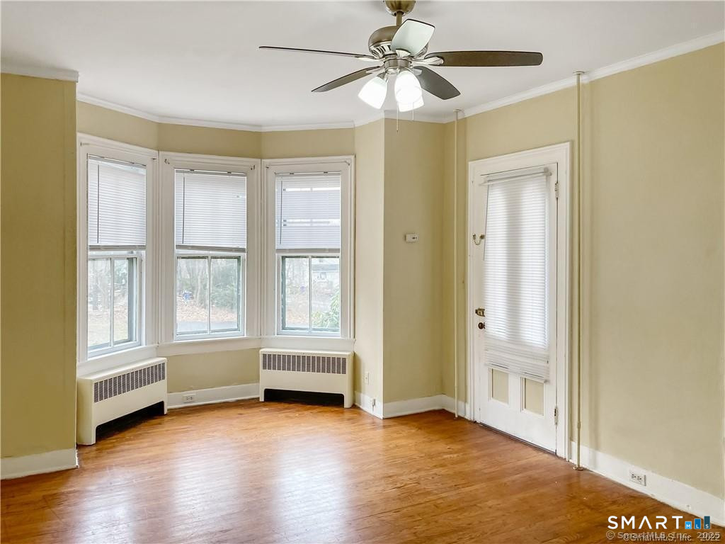 10 Wall Street Middletown, CT 06457 - Photo 4 of 10 an empty room with wooden floor fan and windows