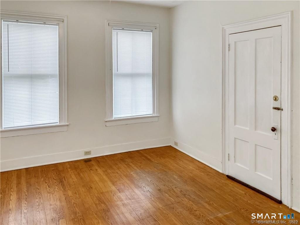 10 Wall Street Middletown, CT 06457 - Photo 6 of 10 a view of an empty room with wooden floor and a window