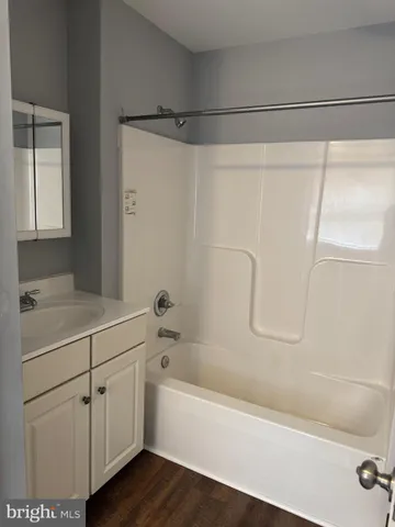 a bathroom with a bathtub and a sink