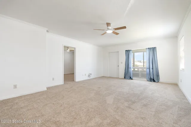 an empty room with a white walls and chandelier