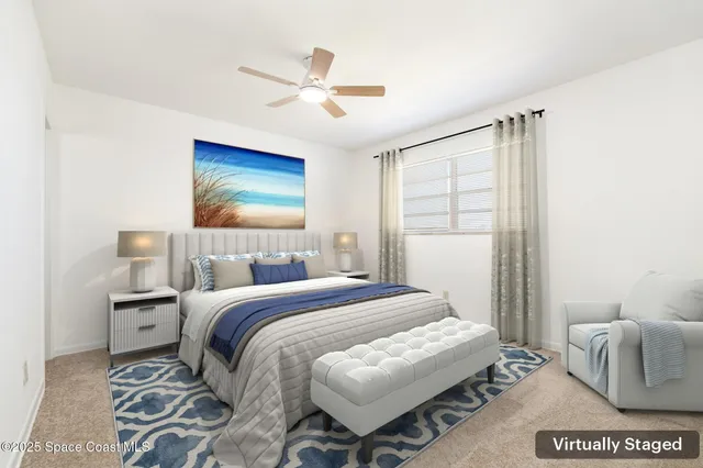 an empty room with a window and a ceiling fan