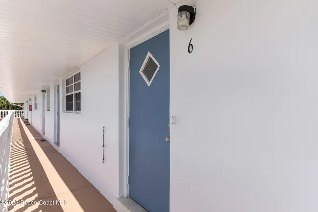 a kitchen with a dining table chairs and refrigerator