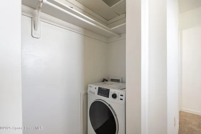 an empty room with a window and a ceiling fan