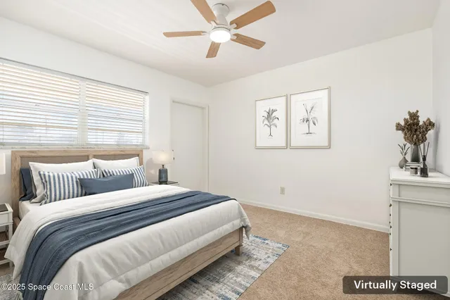 an empty room with a ceiling fan and a window