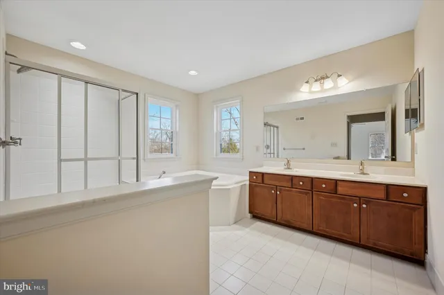 a spacious bathroom with a double vanity sink mirror and double