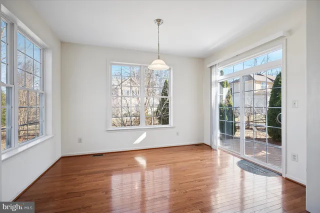 a view of a room window and wooden floor
