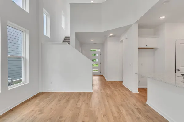 a view of a hallway with wooden floor and staircase
