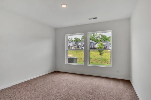 an empty room with a window and doors