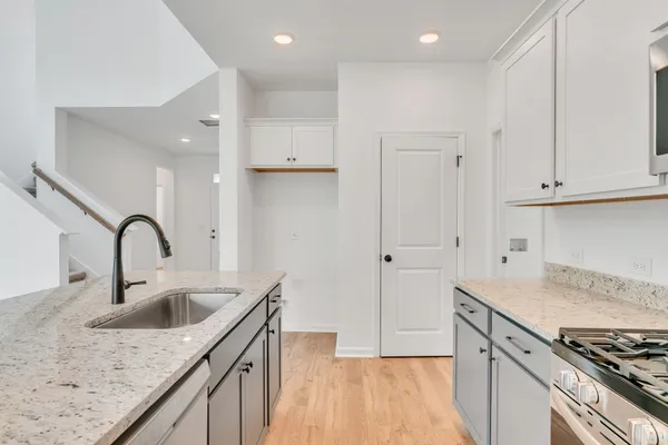 a kitchen with a sink stove and cabinets