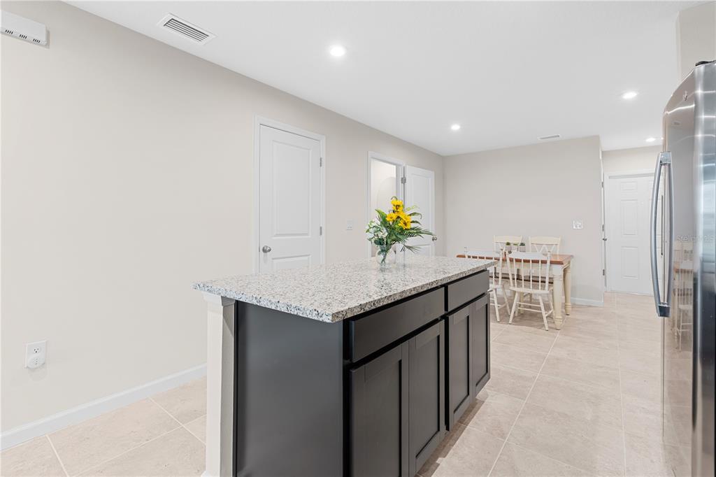 12003 Grizzly Lane New Port Richey, FL 34654 - Photo 16 of 43 a kitchen with stainless steel appliances granite countertop a sink and a refrigerator