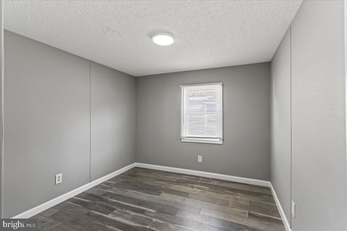 92 Patuxent Mobile Estates Lothian, MD 20711 - Photo 13 of 19 an empty room with wooden floor and windows