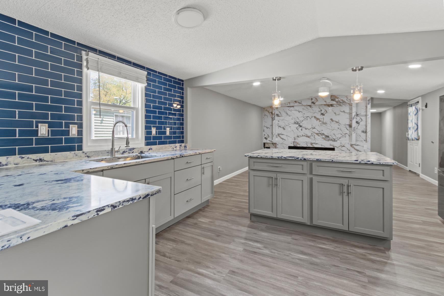92 Patuxent Mobile Estates Lothian, MD 20711 - Photo 2 of 19 a large kitchen with stainless steel appliances granite countertop a sink and a stove
