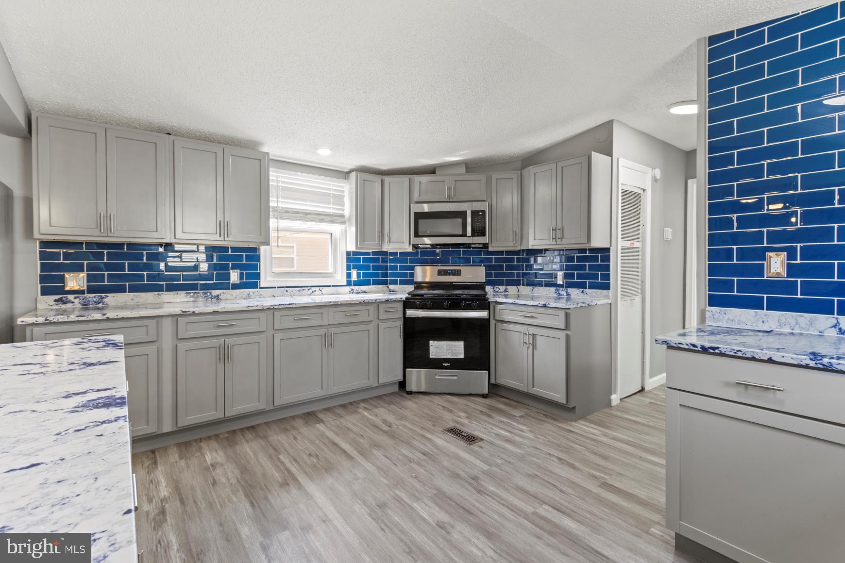 92 Patuxent Mobile Estates Lothian, MD 20711 - Photo 3 of 19 a kitchen with granite countertop wooden cabinets and white appliances