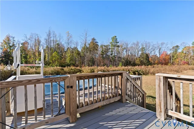 a view of a balcony with wooden fence and floor