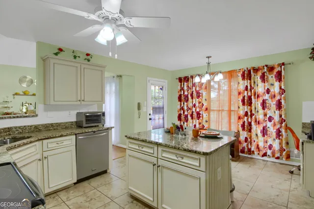 a kitchen with stainless steel appliances a stove a sink and a microwave