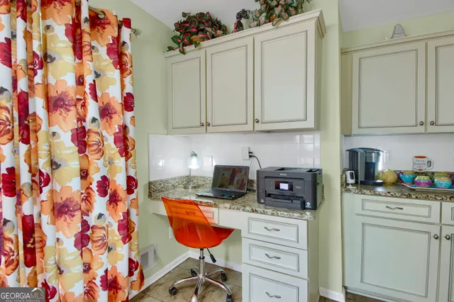 a bedroom with a bed chandelier and dresser