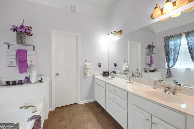 a bathroom with a bathtub and a window