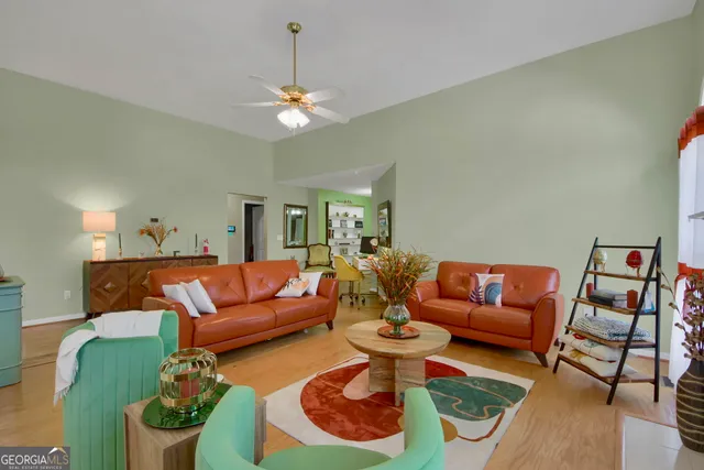 a dining room with furniture a chandelier and wooden floor