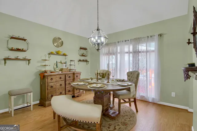 a kitchen with a dining table and chairs