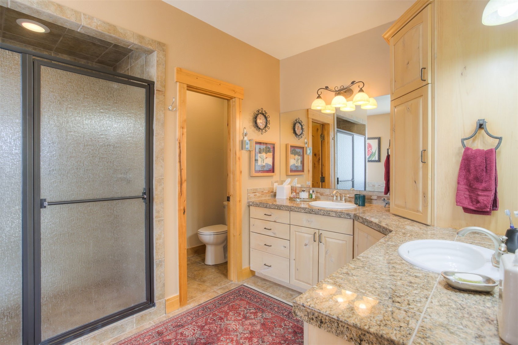 727 Willowbrook Road Silverthorne, CO 80498 - Photo 26 of 47 a spacious bathroom with a granite countertop sink toilet a mirror a vanity and shower