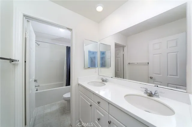 a bathroom with a sink double vanity granite tub and shower