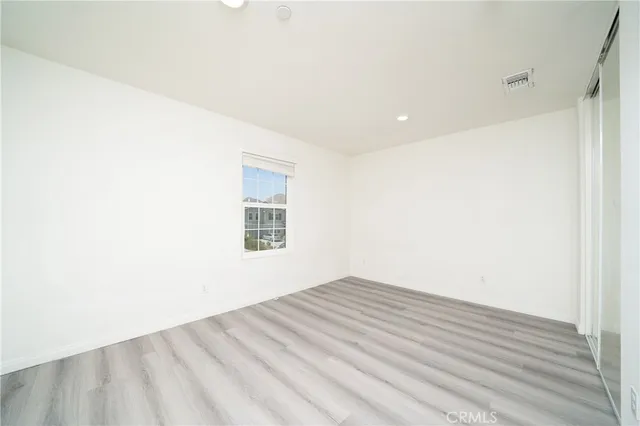 a view of a room with wooden floor and white walls