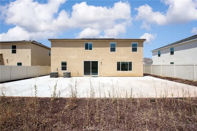 a view of a white house with a yard