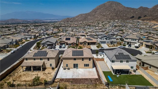 an aerial view of a house with a yard
