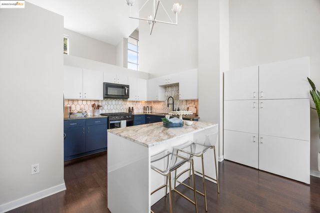 a kitchen with cabinets a sink and appliances