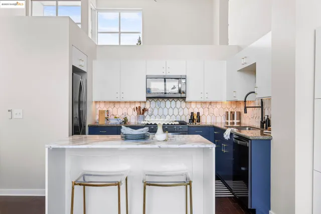 a view of kitchen with cabinets table and chairs