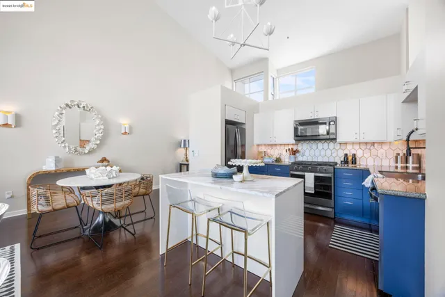a large kitchen with a large counter top space and stainless steel appliances