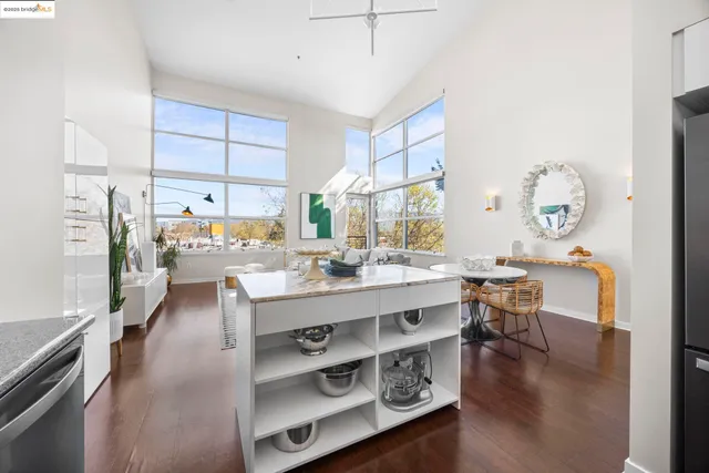 a kitchen with stainless steel appliances granite countertop a stove a sink dishwasher and a microwave oven with wooden cabinets