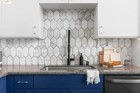 a stove top oven sitting inside of a kitchen