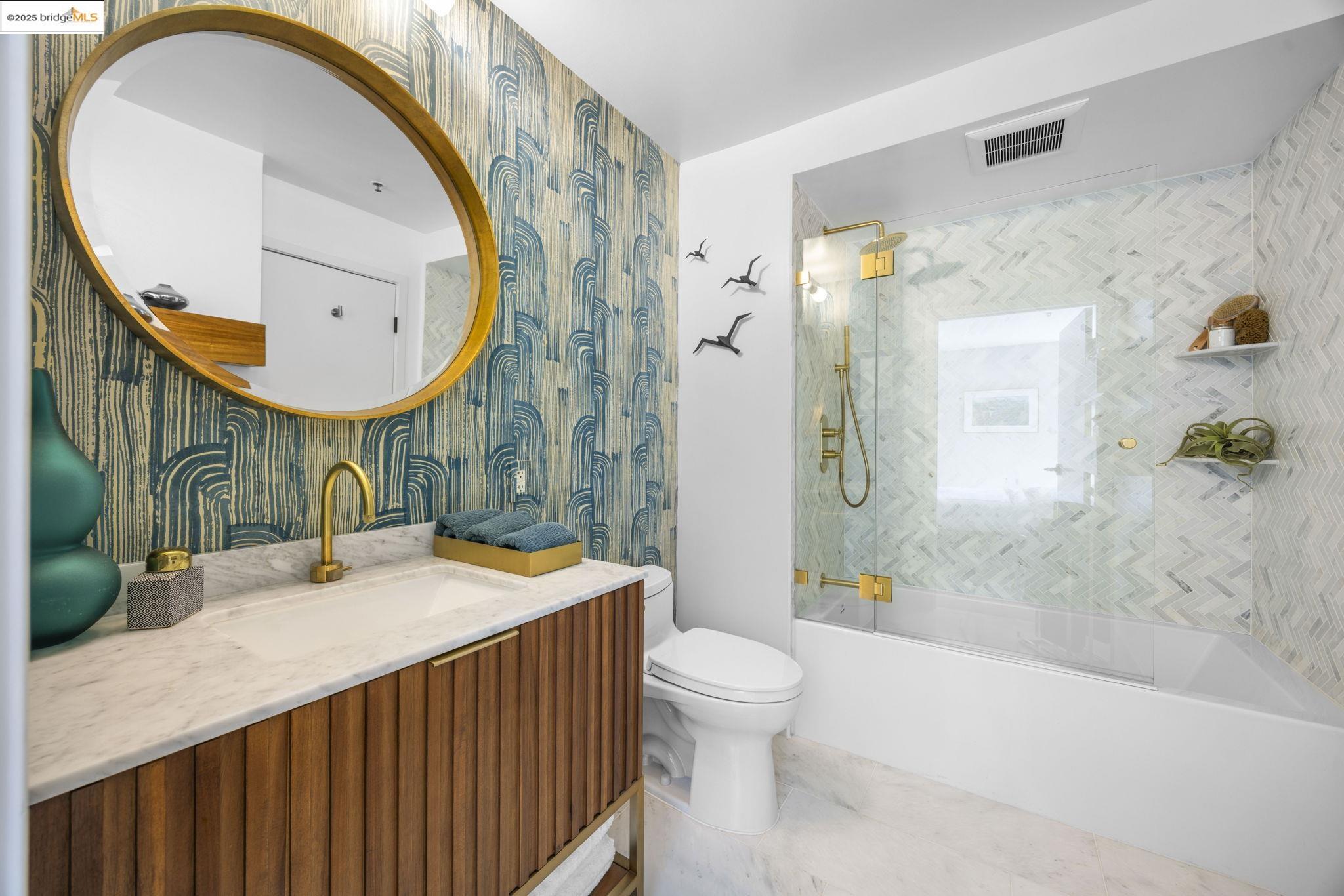 1007 41st Street, Unit 334 Oakland, CA 94608 - Photo 27 of 59 a bathroom with a sink a mirror and a toilet