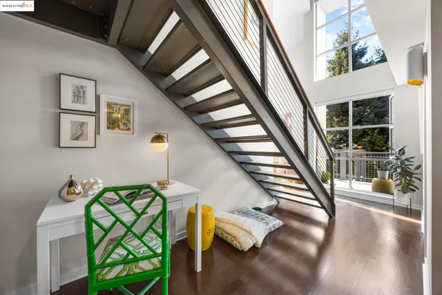 a bedroom with a bed and a wall painting