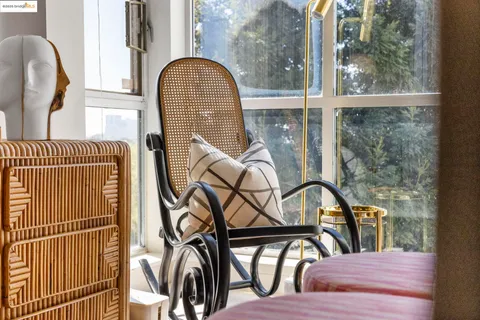 a view of a balcony with wooden floor and a potted plant