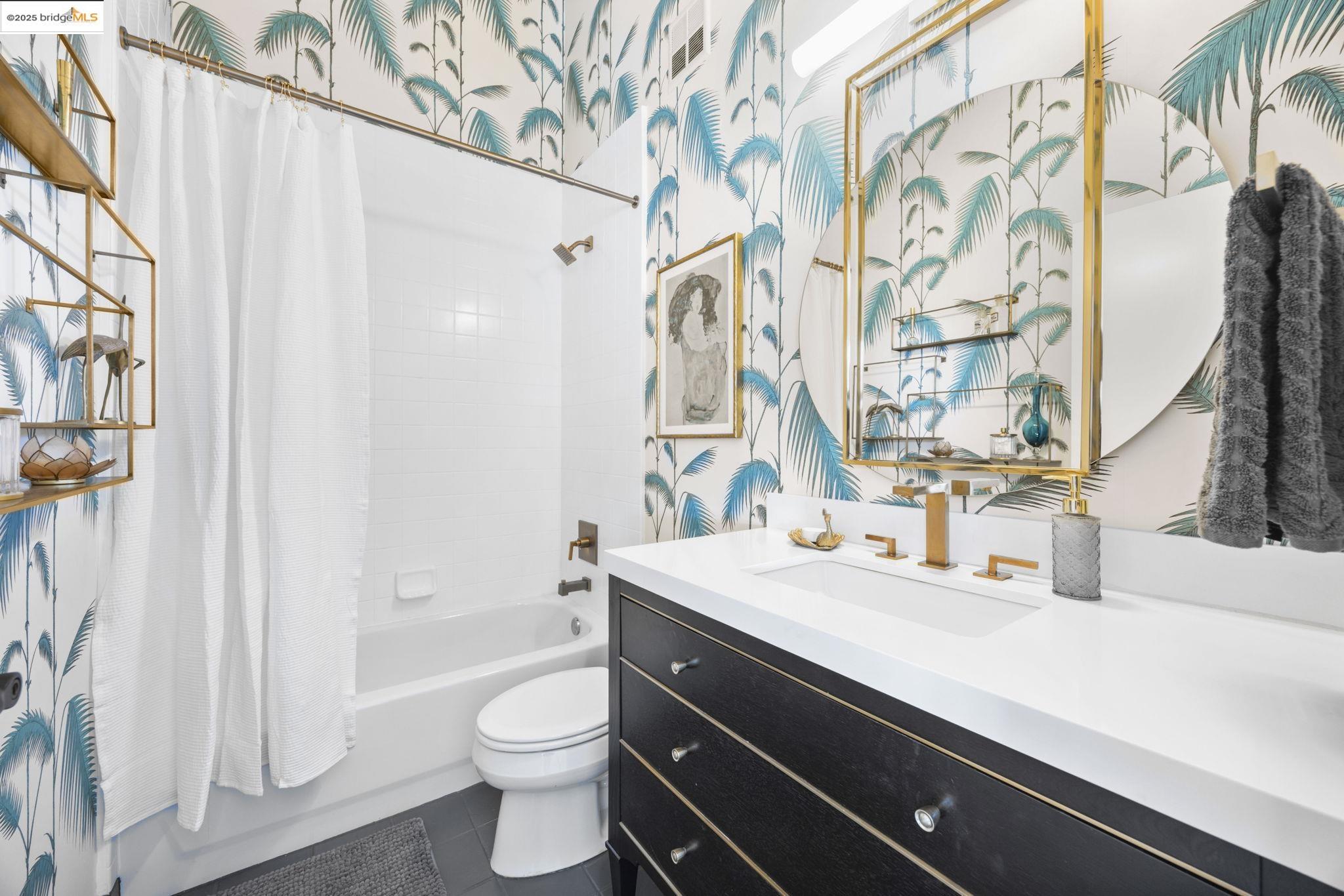 1007 41st Street, Unit 334 Oakland, CA 94608 - Photo 43 of 59 a bathroom with a sink a toilet and a mirror